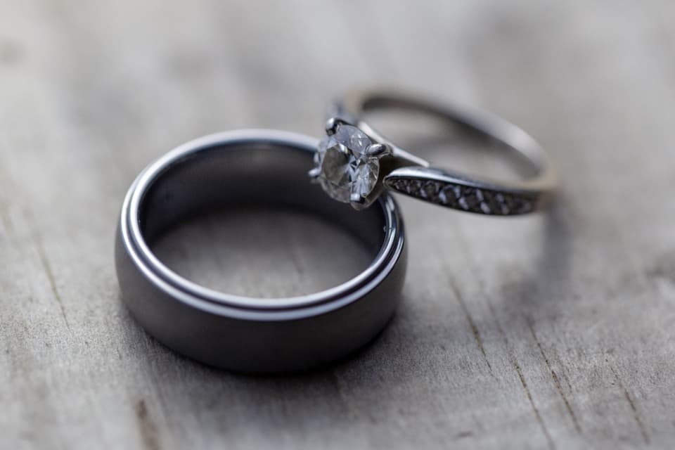 A pair of wedding bands resting on wood